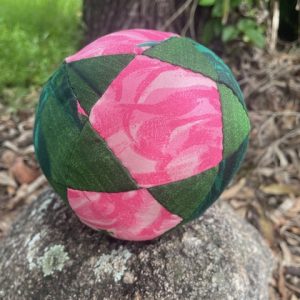 Handmade fabric ball. Green and pink fabric