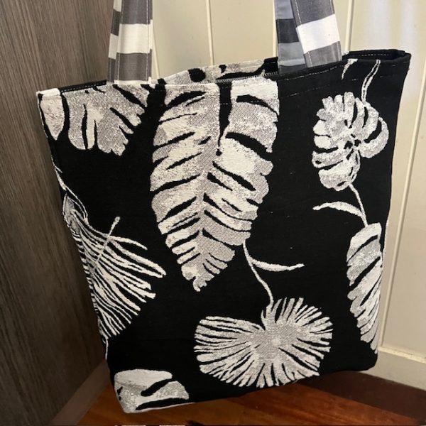 Black and white bag with a tropical leaf pattern