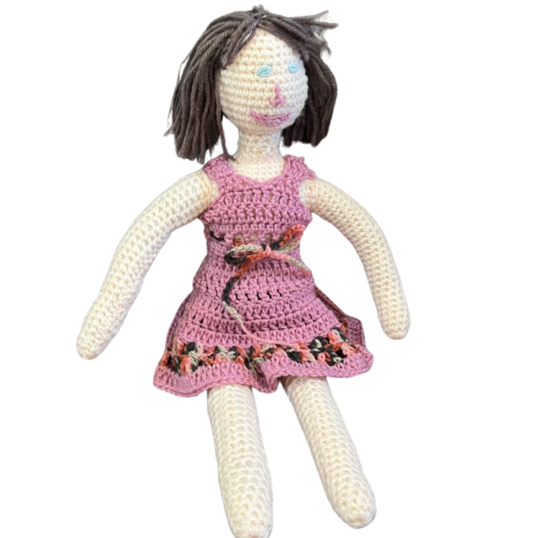 hand-crocheted doll complete with a charming pink hand-crocheted dress